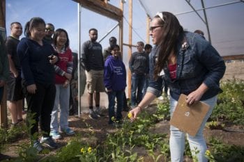 Engineering students from Washington University in St. Louis participated in tour of EarthDance Farms in Ferguson, Mo. Thursday, March 17, 2016, as part of a Spring Break class taught by Sandra Matteucci and Seema Dahlheimer. Kaitie Adams (CQ), Volunteer Coordinator at EarthDance Farms, describes growing techniques used in a hoop greenhouse. Photo by Sid Hastings / WUSTL Photos